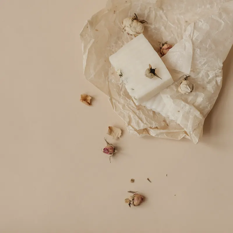 a gift box tied with string, held in two hands