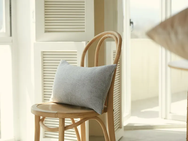 quilted cushion on a wooden chair