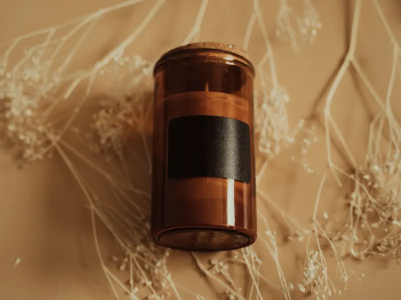 lit candle on a side table at dusk