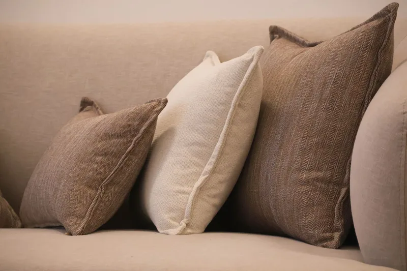 terracotta and linen cushions on a low sofa