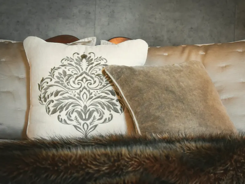 embroidered cushion on a bed